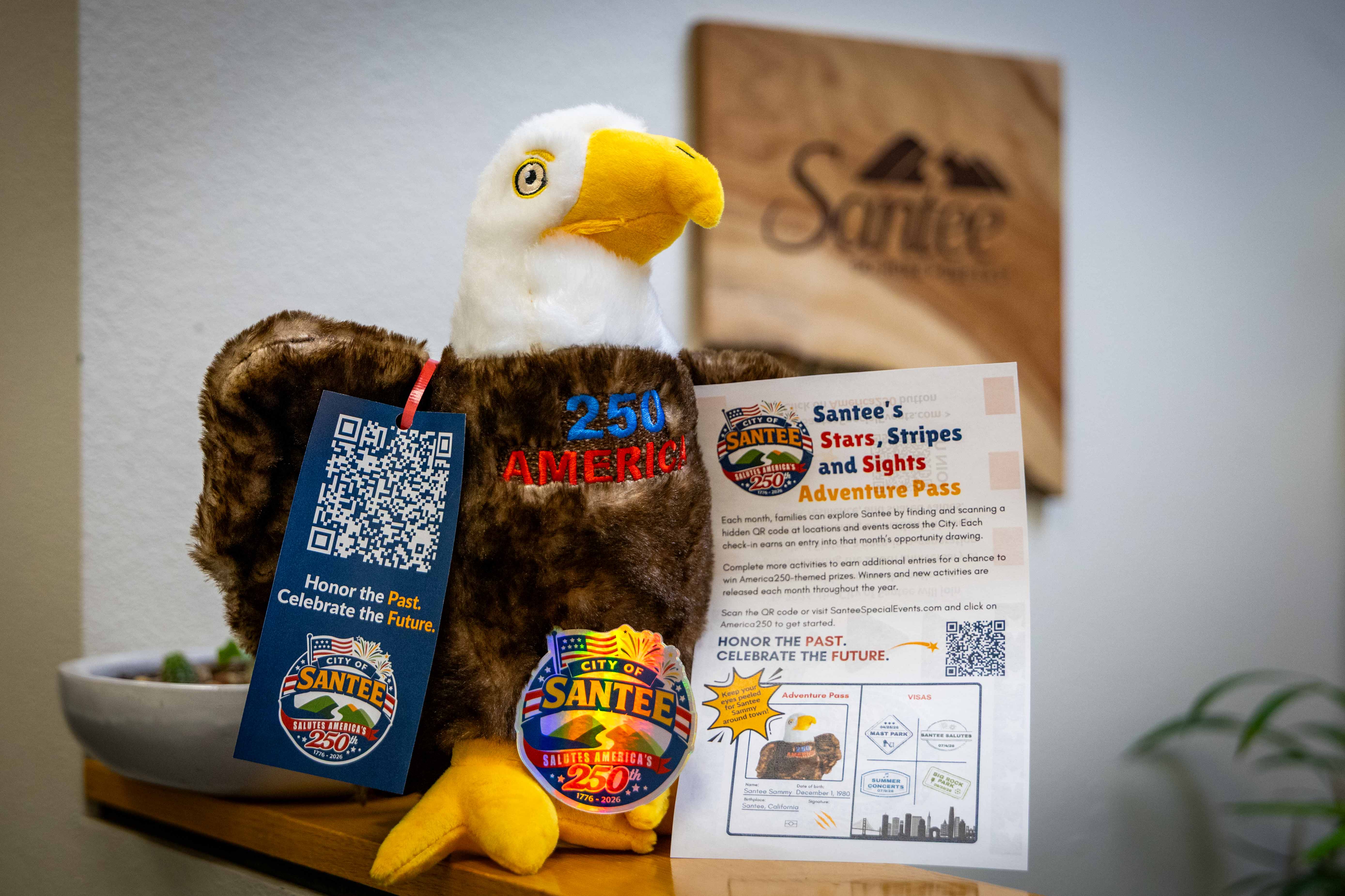 Santee Sammy, a plush bald eagle, with Santee Salutes America 250 merch and promo material.